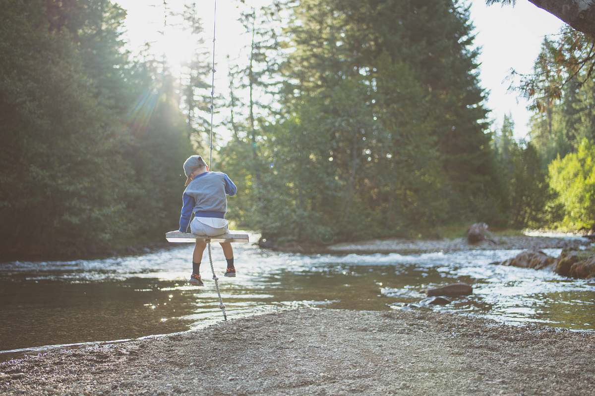 soda springs campground child sitting on swing near river naches